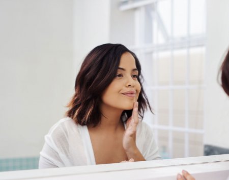 woman looking at her reflection 